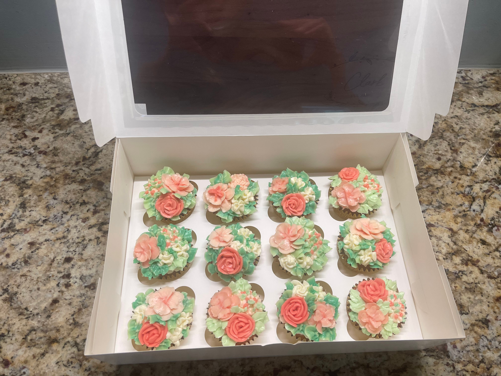 Floral buttercream cupcakes with piped roses and greenery