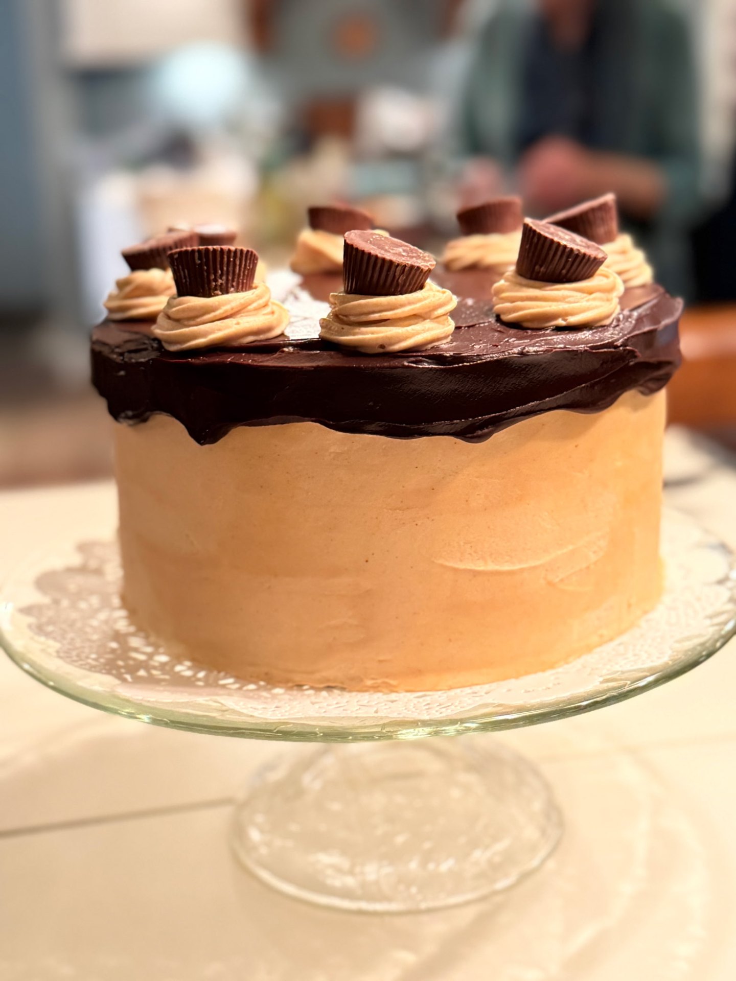 Peanut butter layer cake with chocolate ganache and peanut butter cup toppers