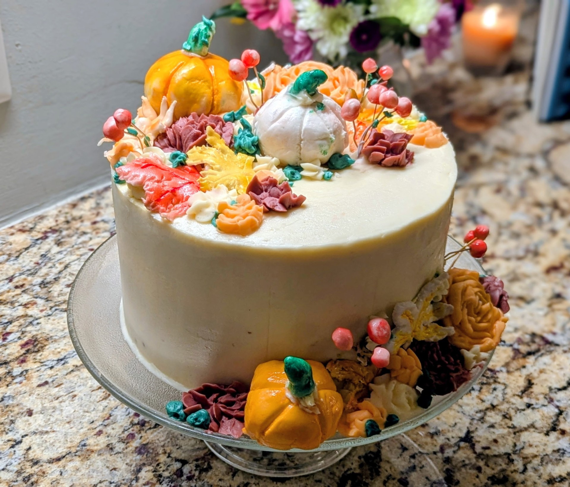 Buttercream cake with fall florals and pumpkins